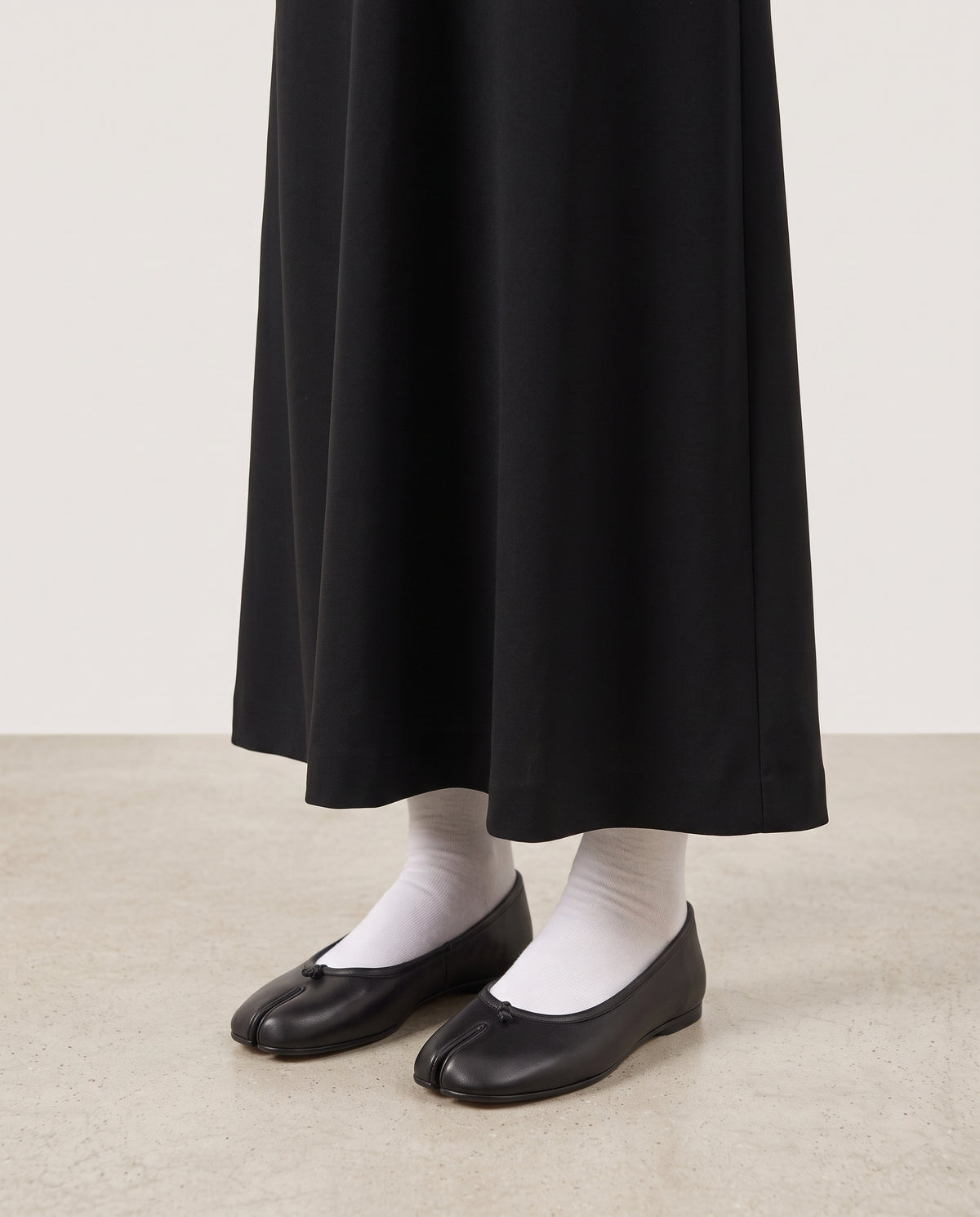 Ballerines Yubi noires portées avec des chaussettes blanches