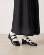 Mary-Janes Yubi noires portées avec des chaussettes blanches